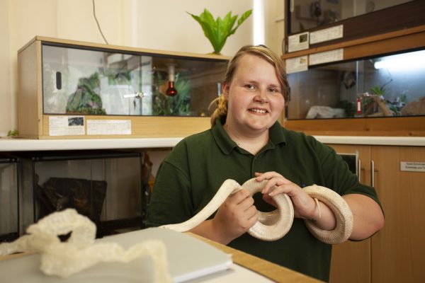 Animal Management student handles a snake